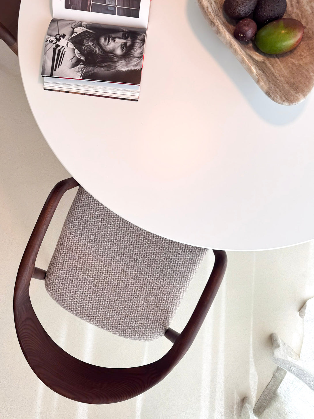 Fabric chair in dark wood, European-made, contemporary setting.
