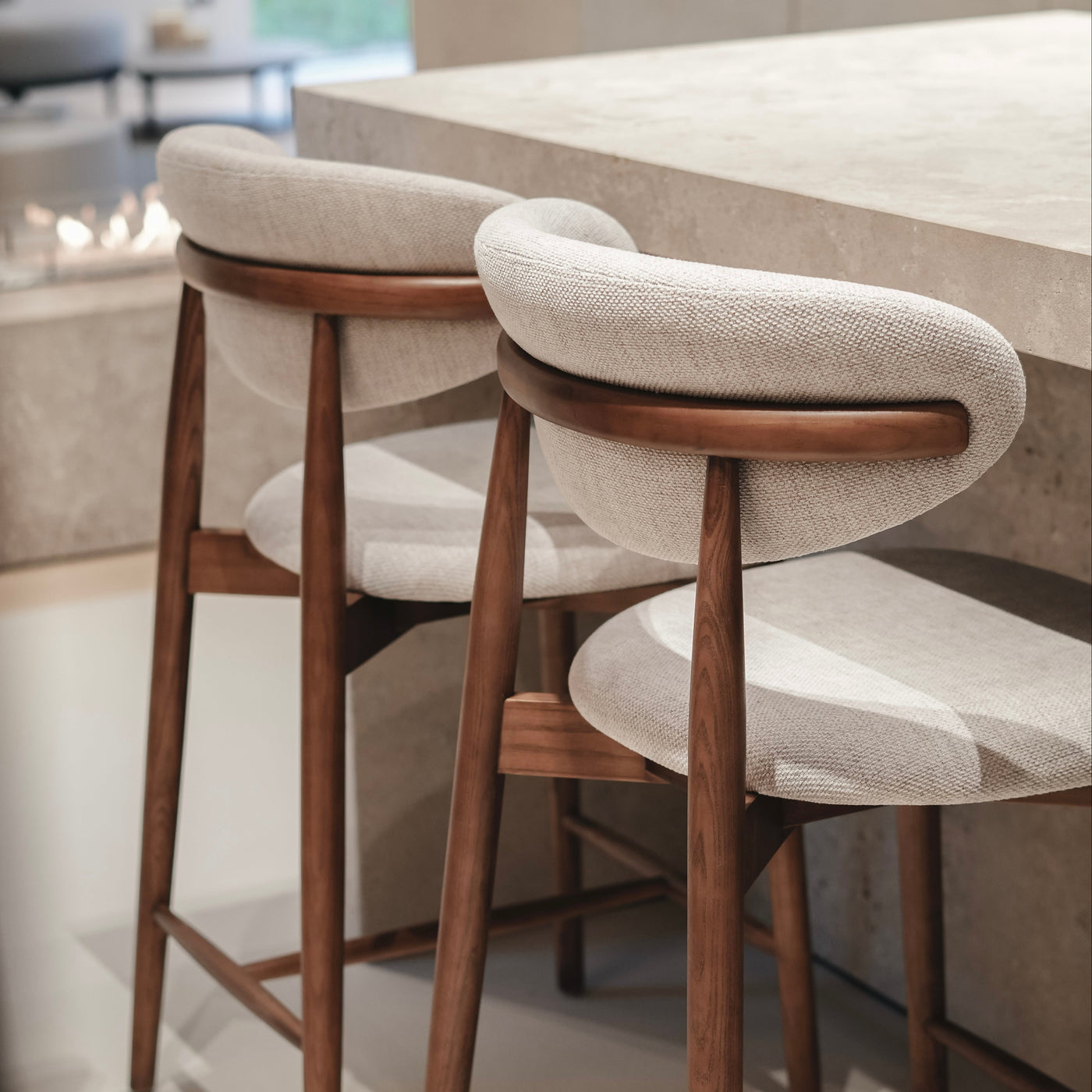 Contemporary kitchen with Mowelli Dianne bar stools in walnut wood and handcrafted upholstery