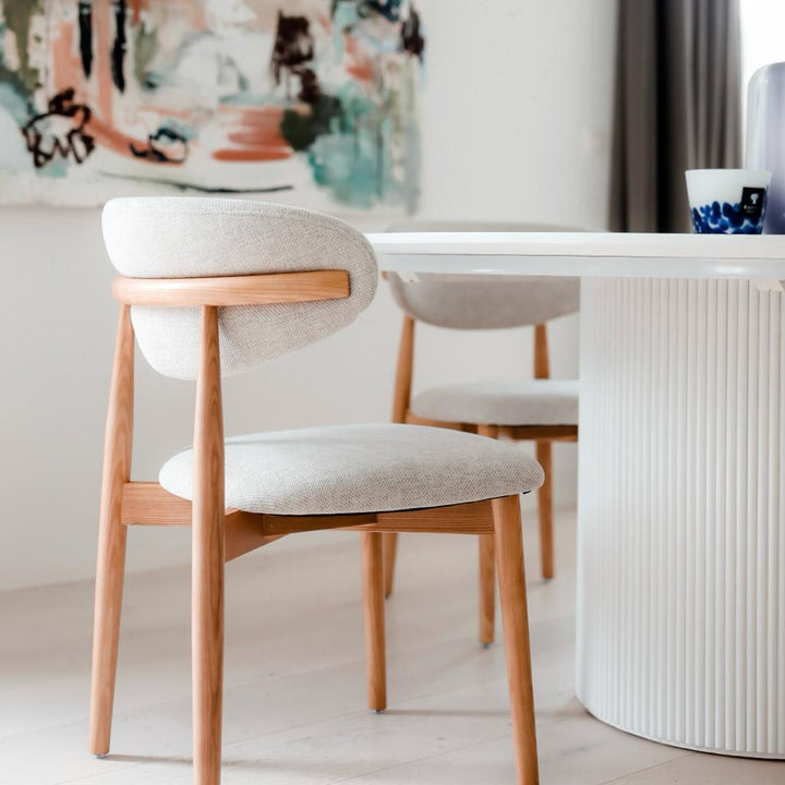 Mowelli Dianne dining chair in natural oak with cream upholstery, styled with modern white dining table