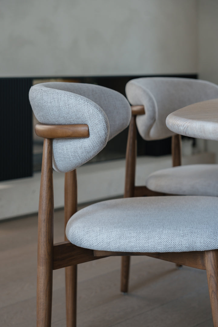 Side view of a Dianny dining chair by Mowelli in walnut ash wood.