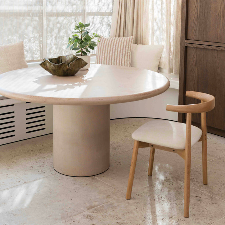 Ella dining chair by Mowelli in natural oak wood paired with a round modern dining table