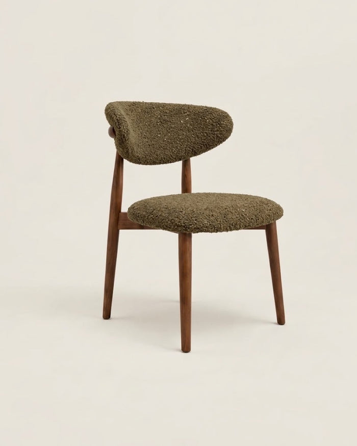 t4option0_4 | A mid-century modern side chair featuring a textured, shaggy olive green upholstered seat and backrest, supported by four tapered walnut wooden legs, set against a solid off-white background.