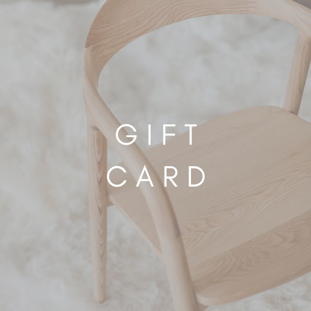 A wooden Nora chair with the words 'GIFT CARD' displayed on it, set against a white background.