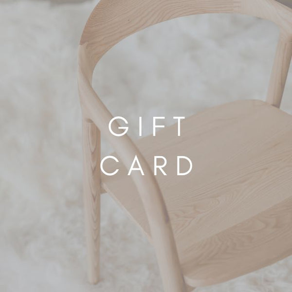 A wooden Nora chair with the words 'GIFT CARD' displayed on it, set against a white background.