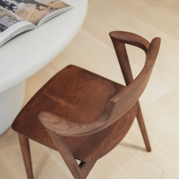 Top view of Jules wooden chair by Mowelli – minimalist Belgian design with smooth curved backrest and solid seat