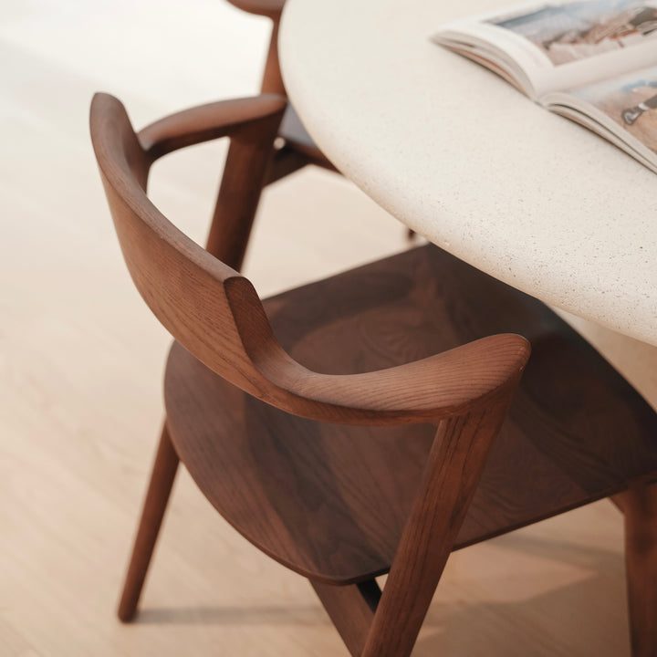 Detail of Mowelli’s Jules chair – sculpted wooden armrest and ergonomic backrest in handcrafted Belgian design