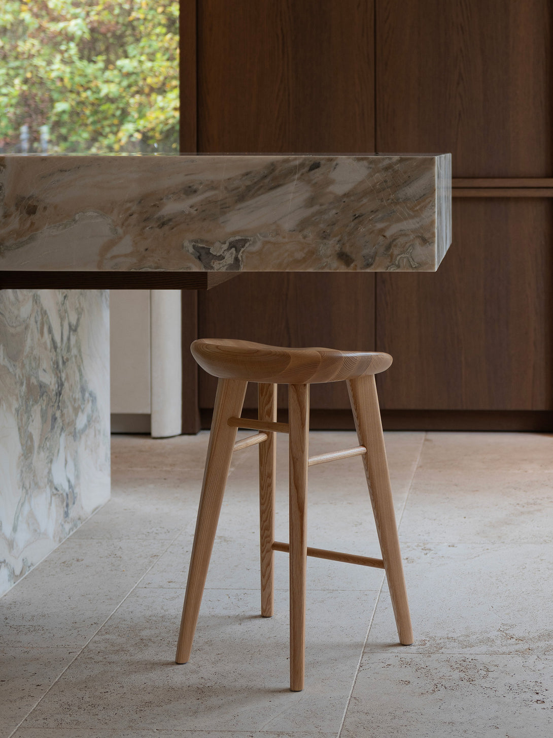 Ollie bar stool by Mowelli in naturel ash wood, styled at a kitchen counter with contemporary minimalist interiors.