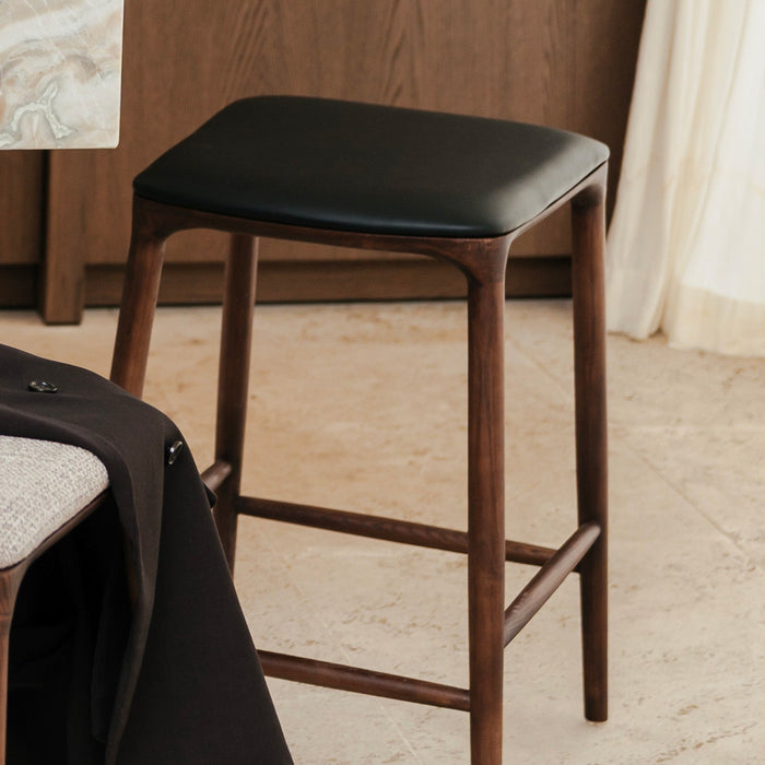 t4option0_1 | Mowelli Nora counter stool in brown walnut wood with premium vegan leather upholstered seat and minimalist backless design.