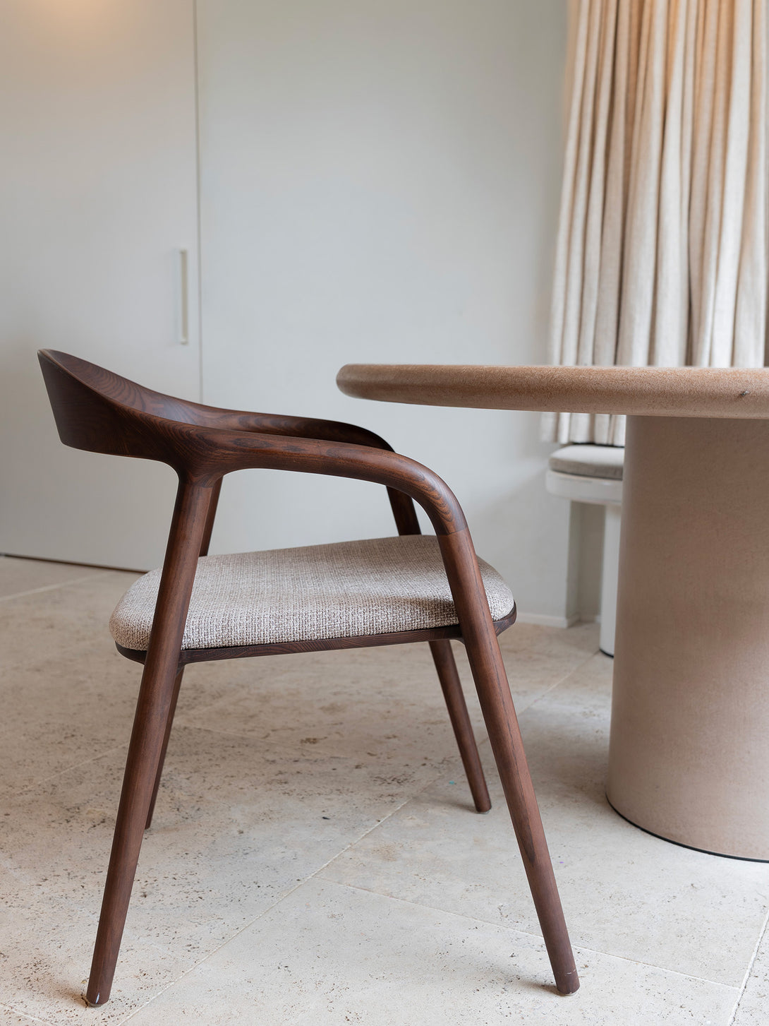 Nora comfort chair by Mowelli – stylish wooden chair in brown walnut with soft upholstered cushion seat, perfect for modern interiors.