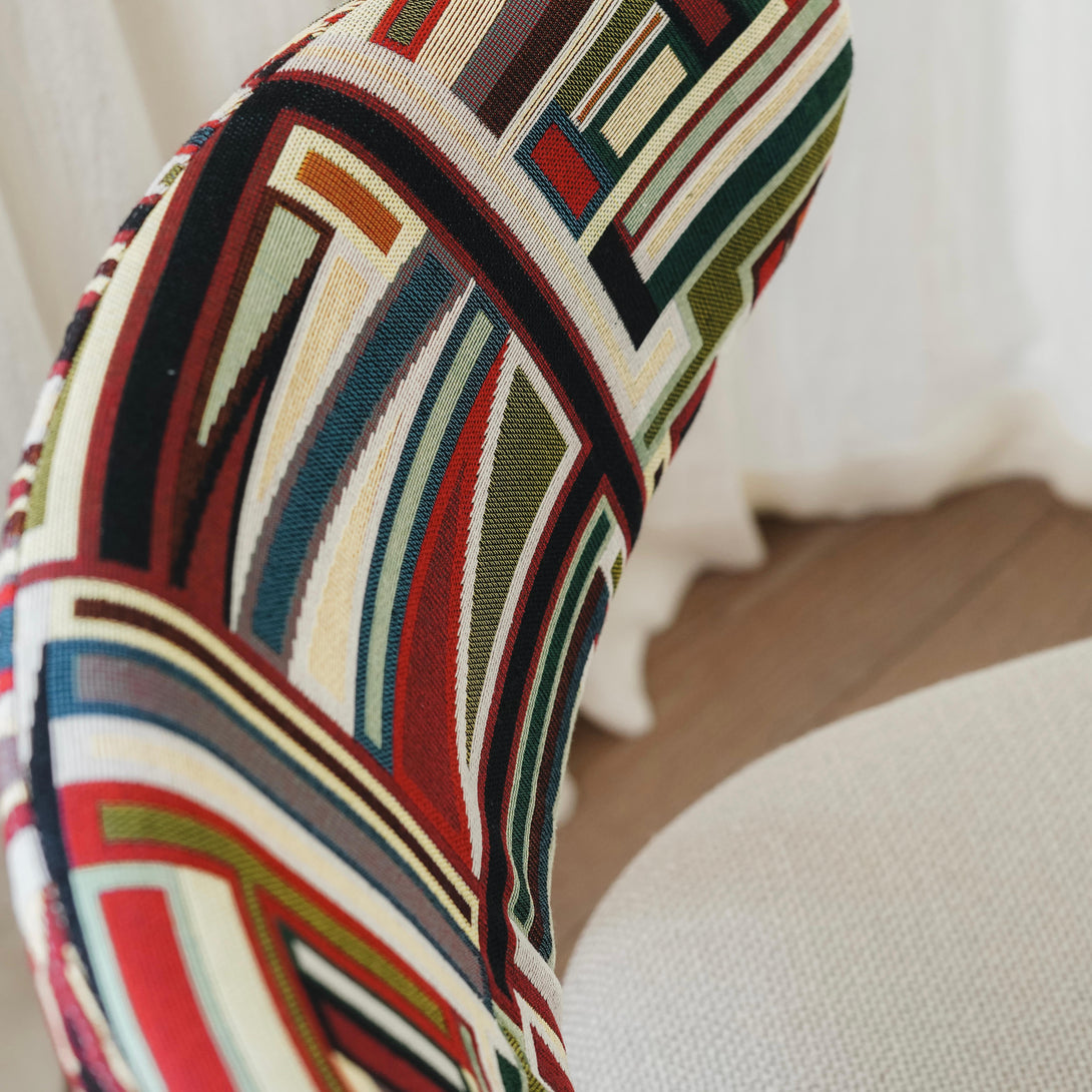 Close-up of Mowelli x Rebo - Coco dining chair, focused on the multicoloured handcrafted fabric seat