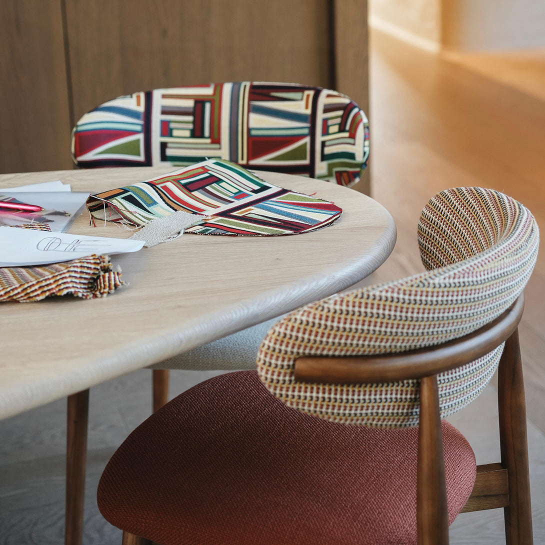 Mowelli x Rebo - Coco and Mowelli x Rebo - Jeanne dining chair standing together at a minimalist table