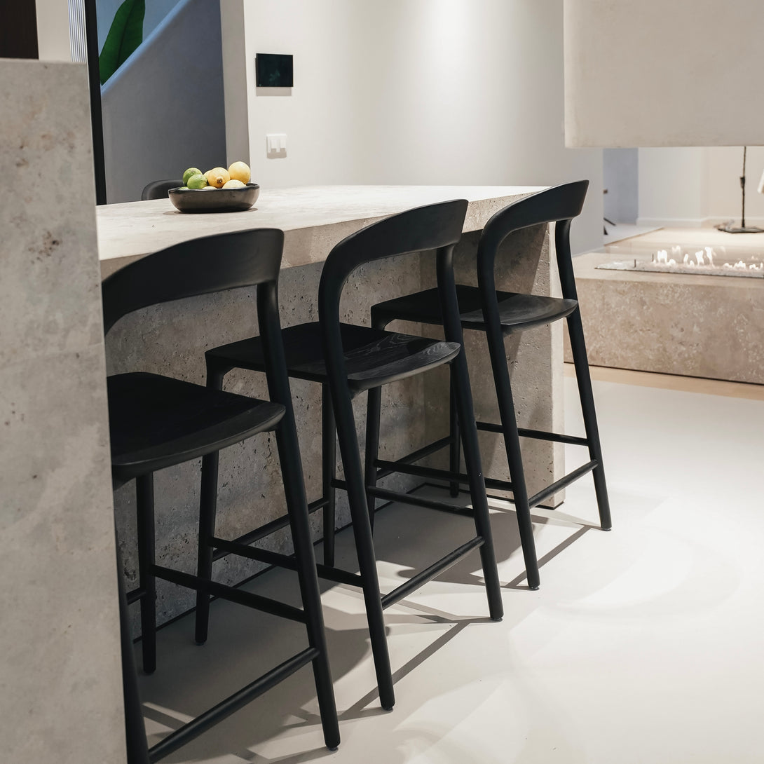 Black Mowelli Nora bar stools at a kitchen island – minimalistic European bar furniture