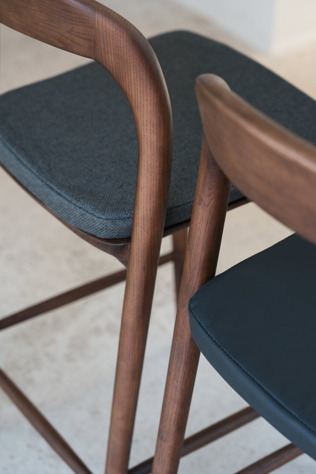 A detailed shot to show the contract between a charcoal black fabric seat and a charcoal black leather seat