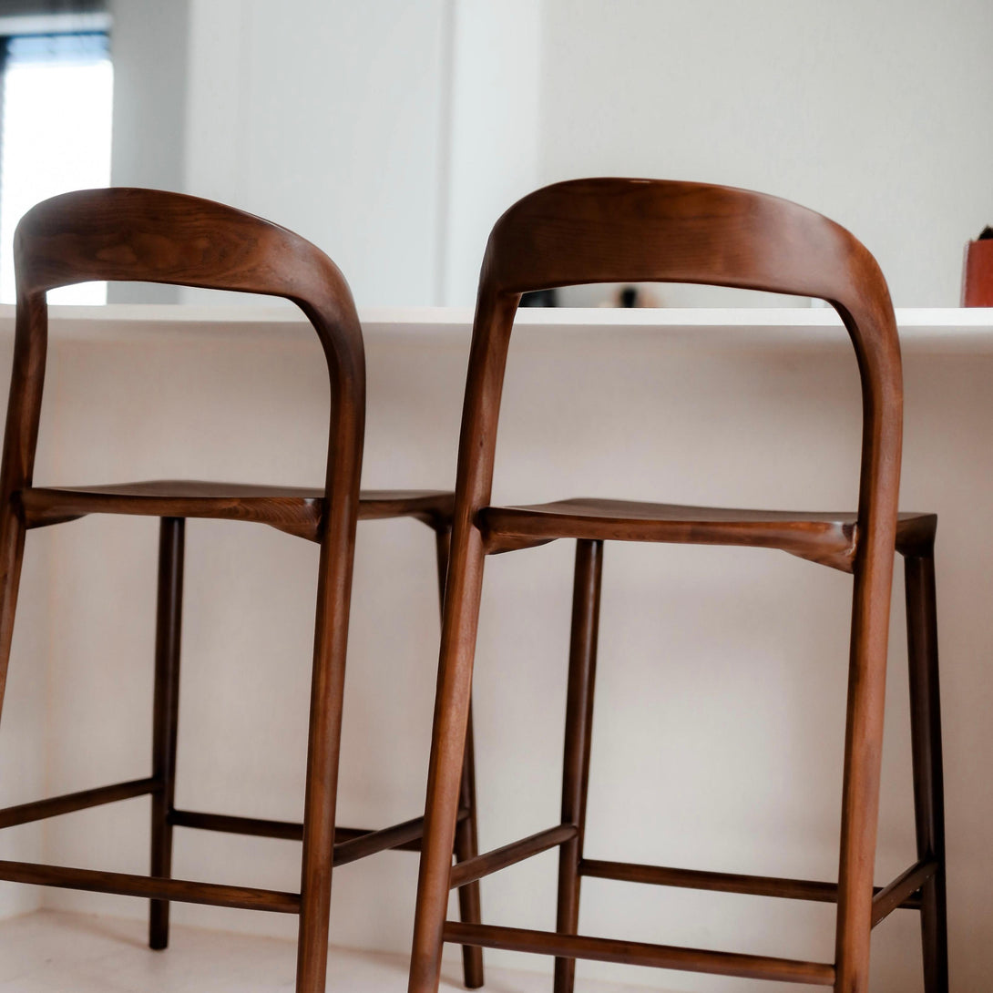 Rear view of walnut Nora bar stools by Mowelli – sustainable handcrafted wooden chairs