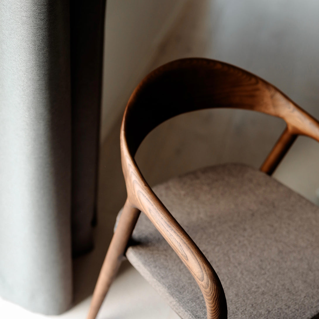 Nora walnut dining chair by Mowelli with a mocha brown fabric seat