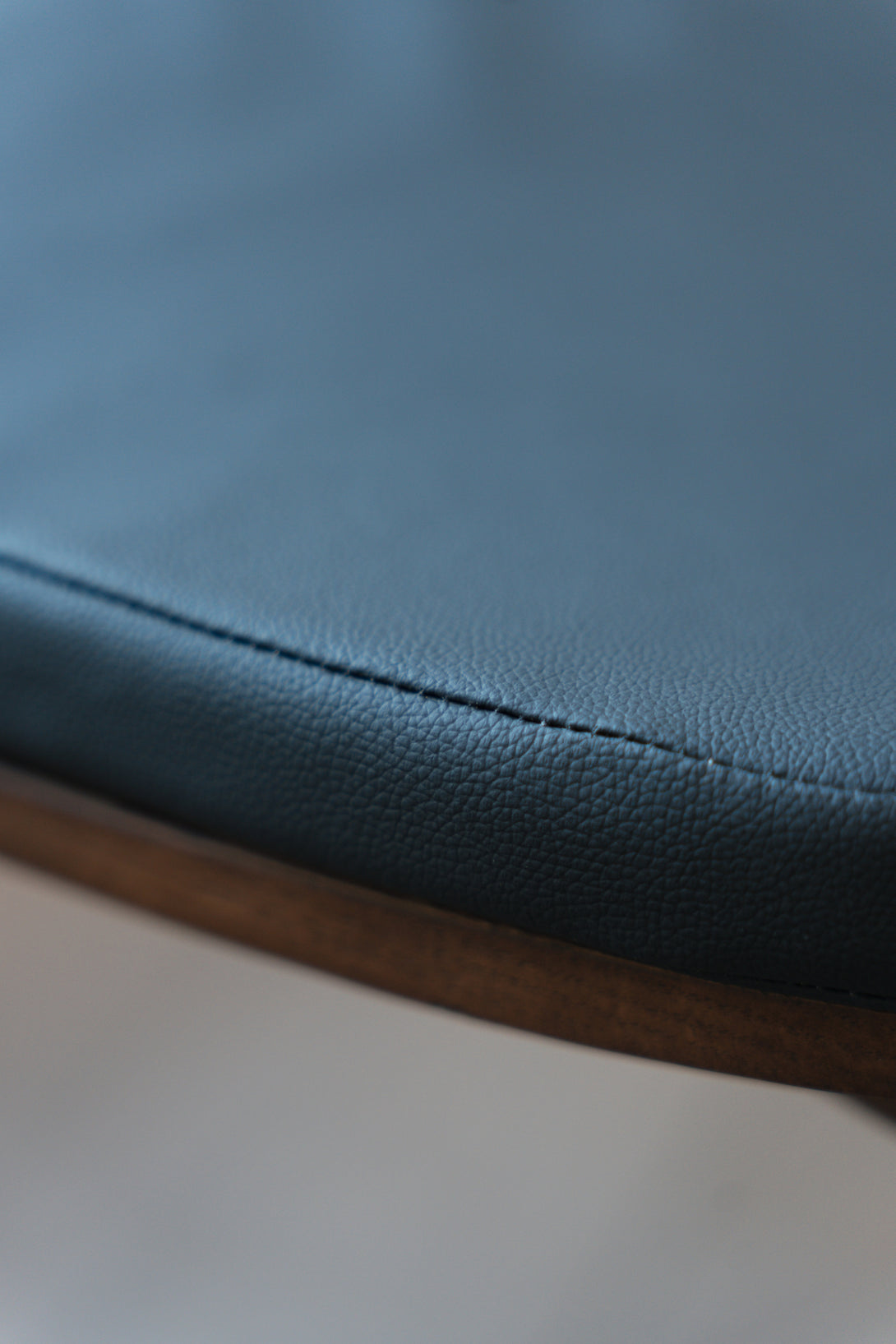 A detailed shot of a charcoal black leather pillow by Mowelli