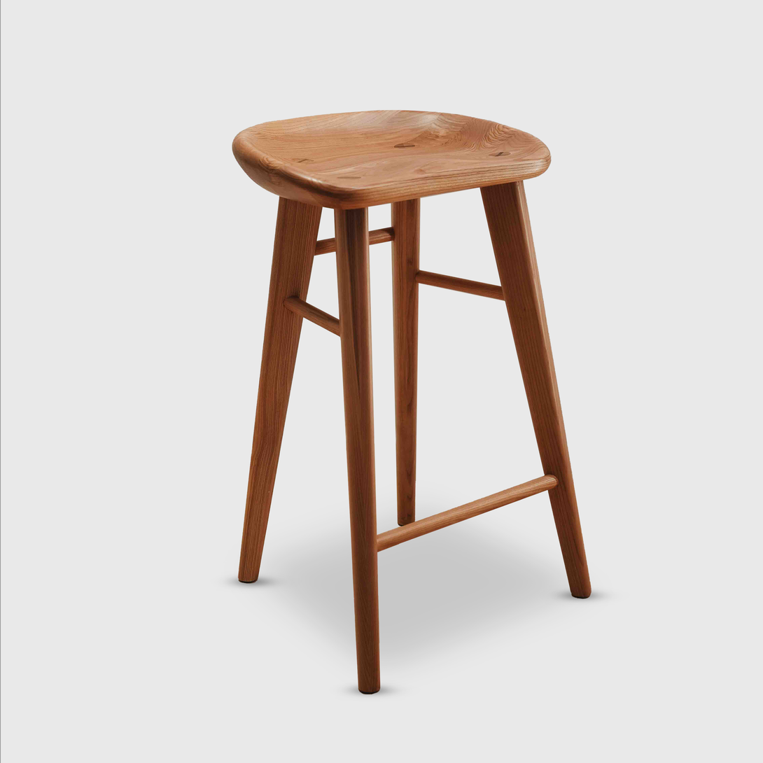 Ollie bar stool by Mowelli in natural ash wood, photographed on white background, showcasing timeless craftsmanship.