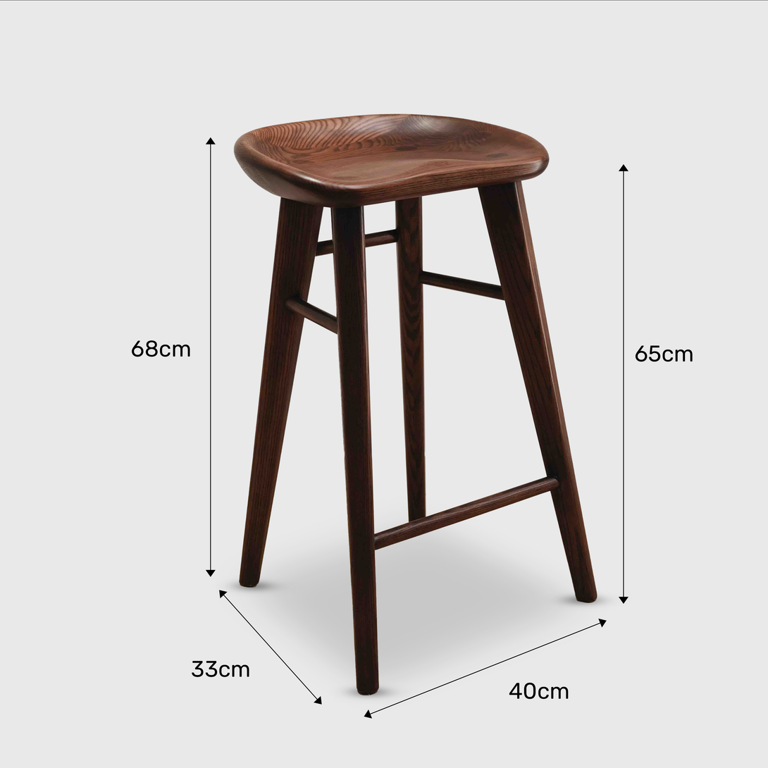 Warm walnut version of Ollie bar stool by Mowelli with dimensions, perfect for elevated seating needs.