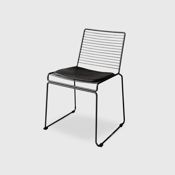 Minimalist black Willow chair with wireframe design on a white background