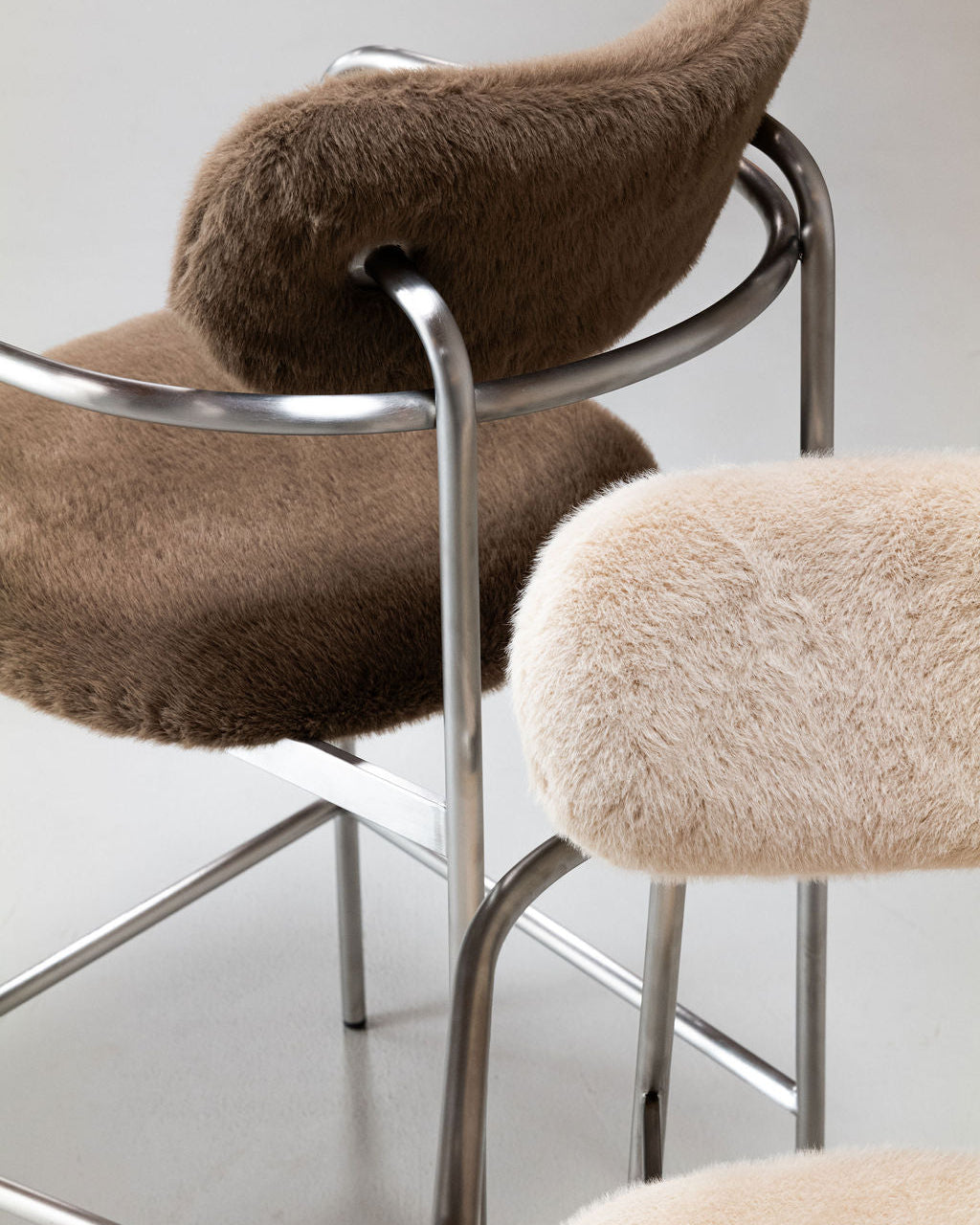 Close-up of Coco bar chair in sage grey and ivory textured upholstery with a brushed stainless steel frame