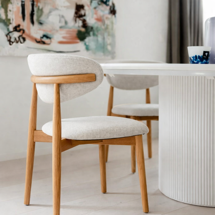 Mowelli Dianne dining chair in natural wood and beige fabric, captured in natural daylight for true color representation