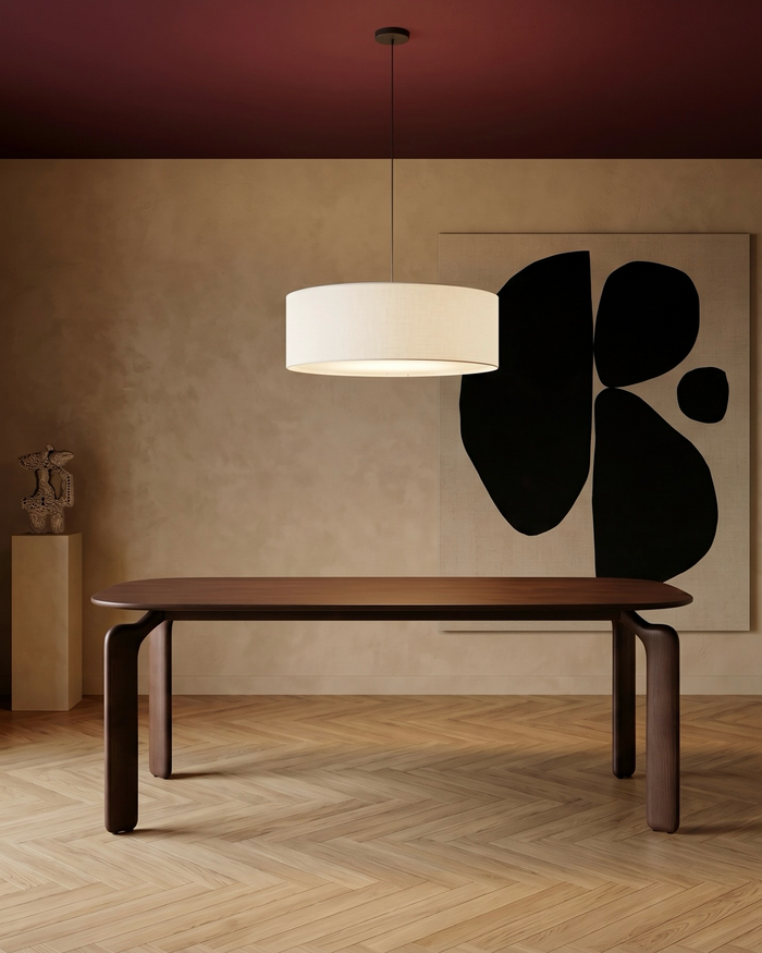 Mowelli Arco dining table in dark walnut, rounded rectangular top with sculptural legs, styled in warm-toned interior with abstract wall art