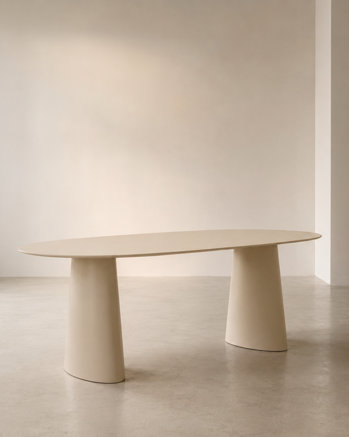 Mowelli Lago oval dining table in soft cream with twin conical pedestal base, studio shot