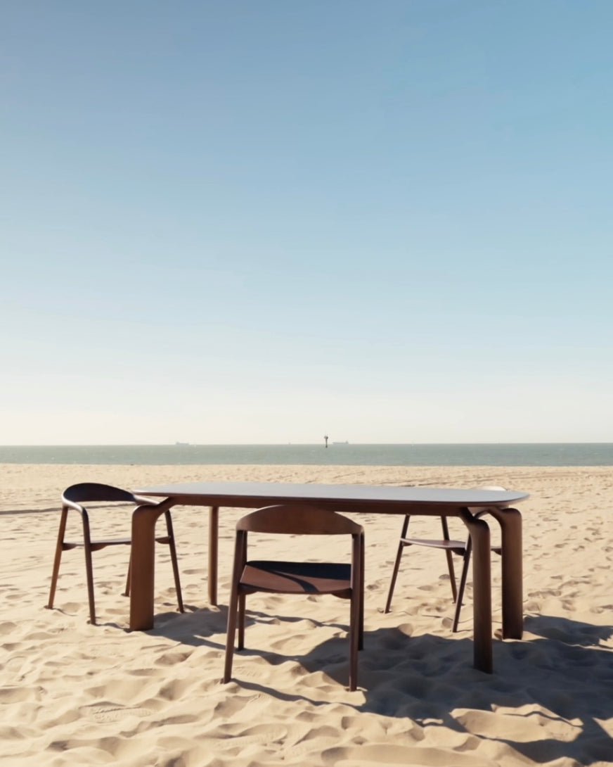 Close-up video of the Arco walnut table design together with Nora dining chairs.